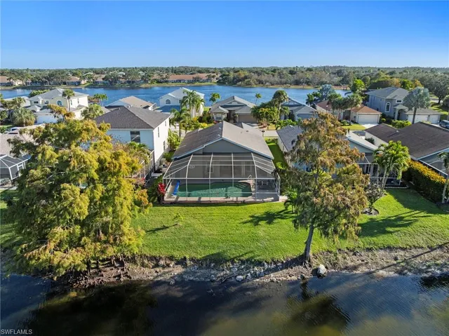 an aerial view of a house with a garden and lake view