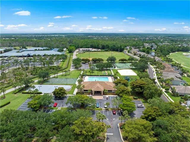 an aerial view of a house with a garden and lake view