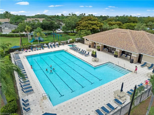 a view of aerial tennis pool yard and outdoor seating