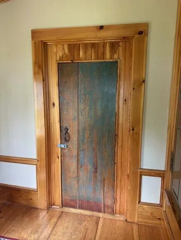 a view of front door with wooden door