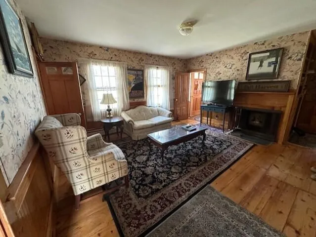 a living room with furniture rug and window