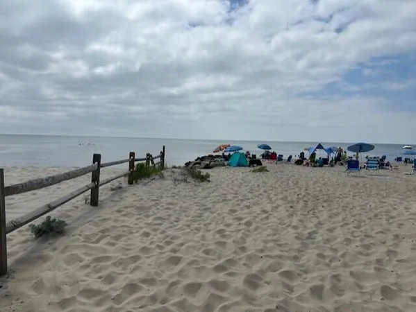 a view of a balcony next to a yard with wooden floor