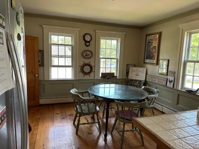 a view of a dining room with furniture and window