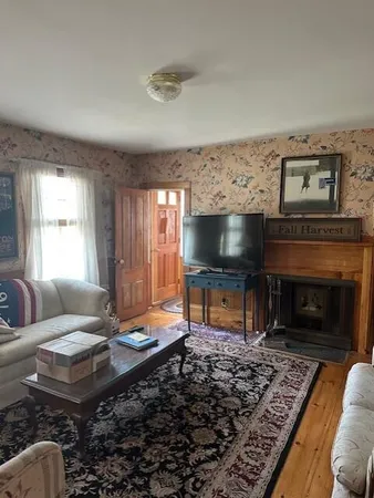 a living room with furniture and a fireplace