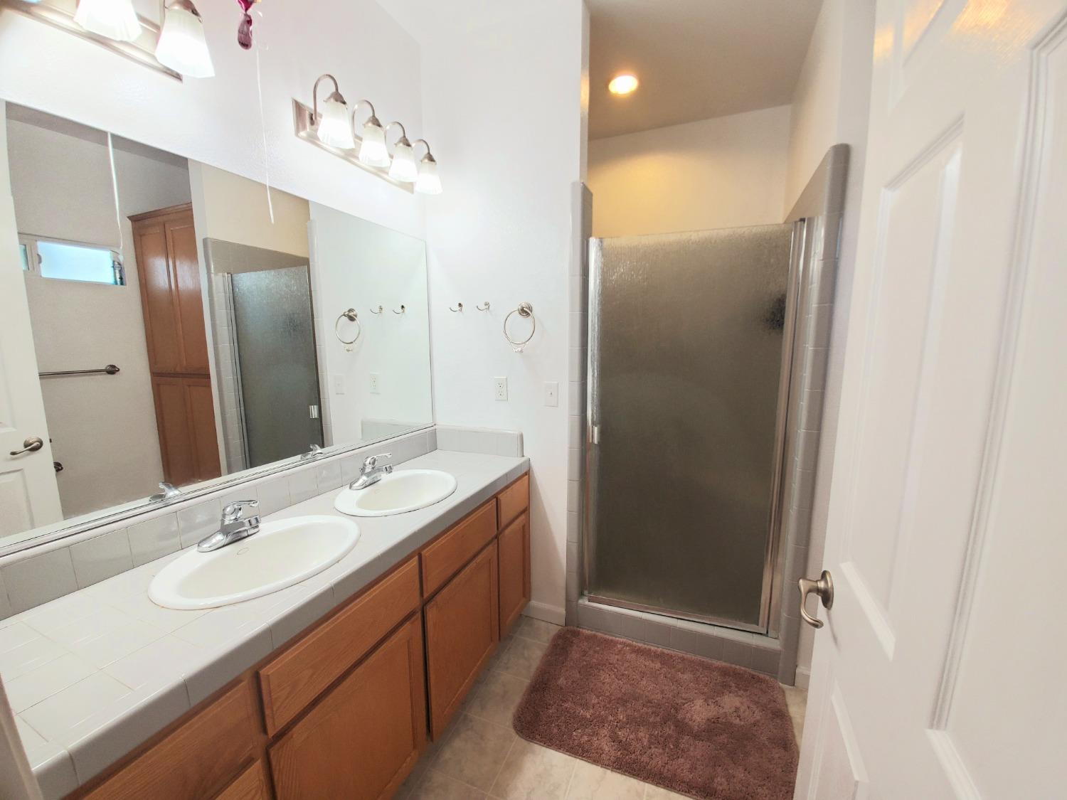 359 Amber Dinuba, CA 93618 - Photo 13 of 22 a bathroom with a sink and a mirror