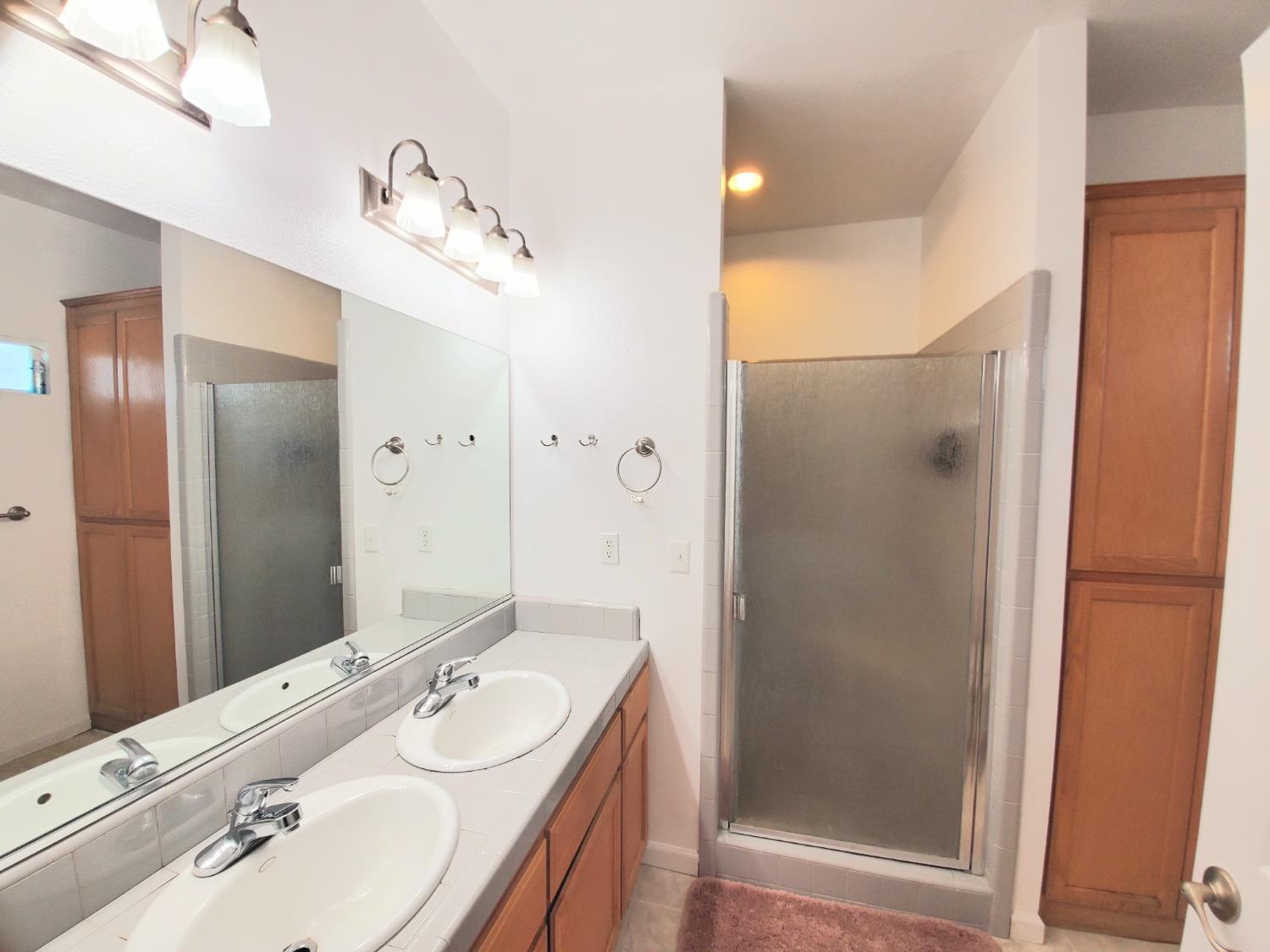 359 Amber Dinuba, CA 93618 - Photo 15 of 22 a bathroom with a double vanity sink mirror and shower