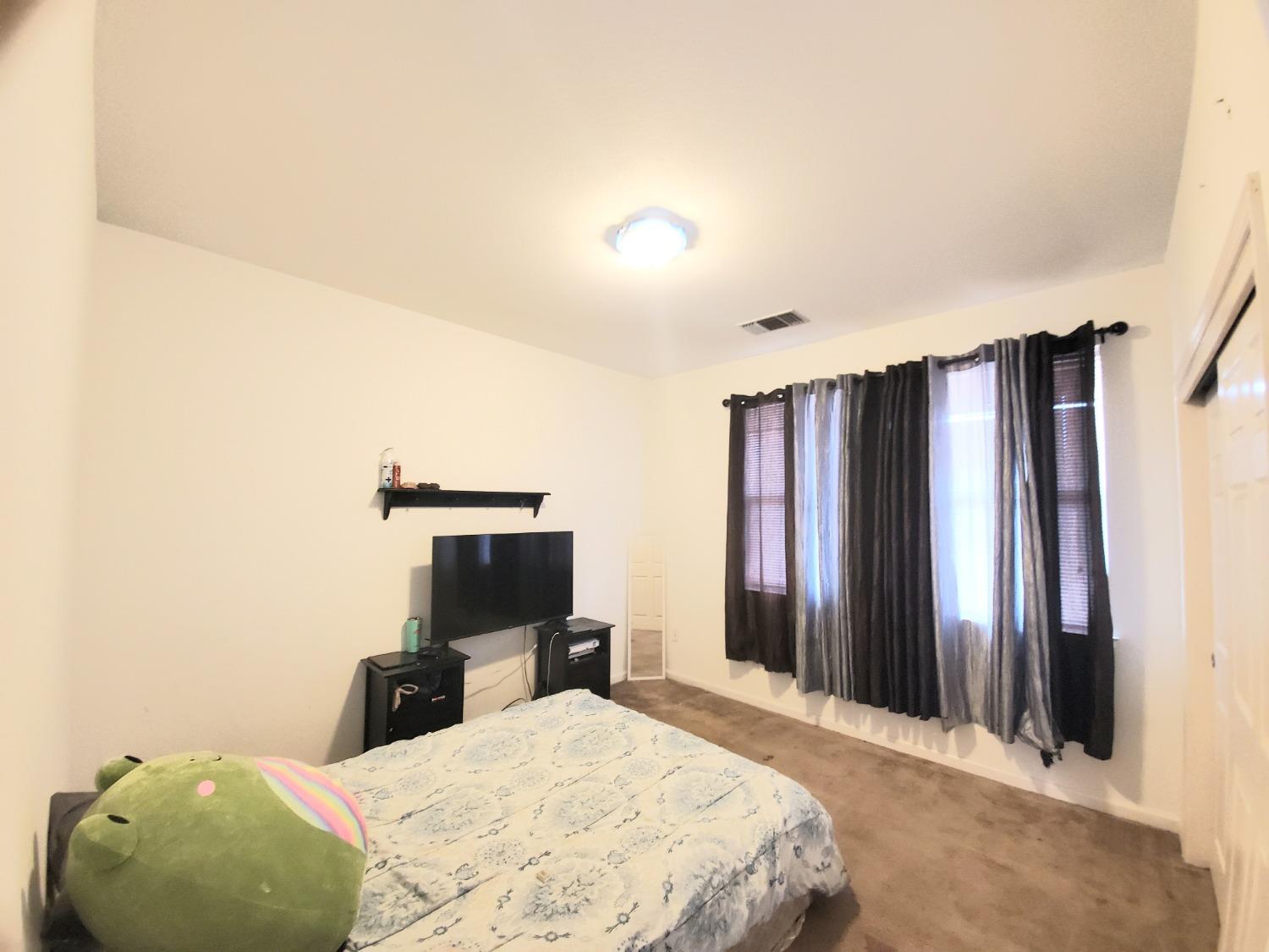 359 Amber Dinuba, CA 93618 - Photo 17 of 22 a bedroom with a bed and a a mirror