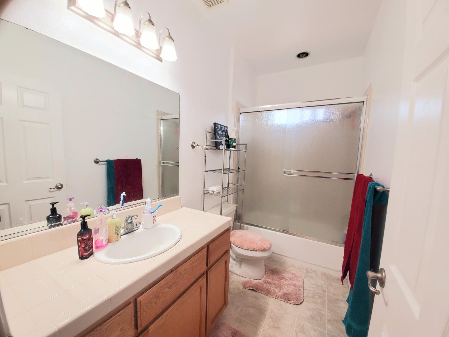 359 Amber Dinuba, CA 93618 - Photo 18 of 22 a bathroom with a sink a toilet and shower