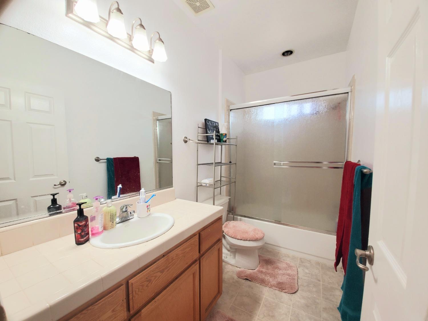 359 Amber Dinuba, CA 93618 - Photo 19 of 22 a bathroom with a sink a toilet and shower