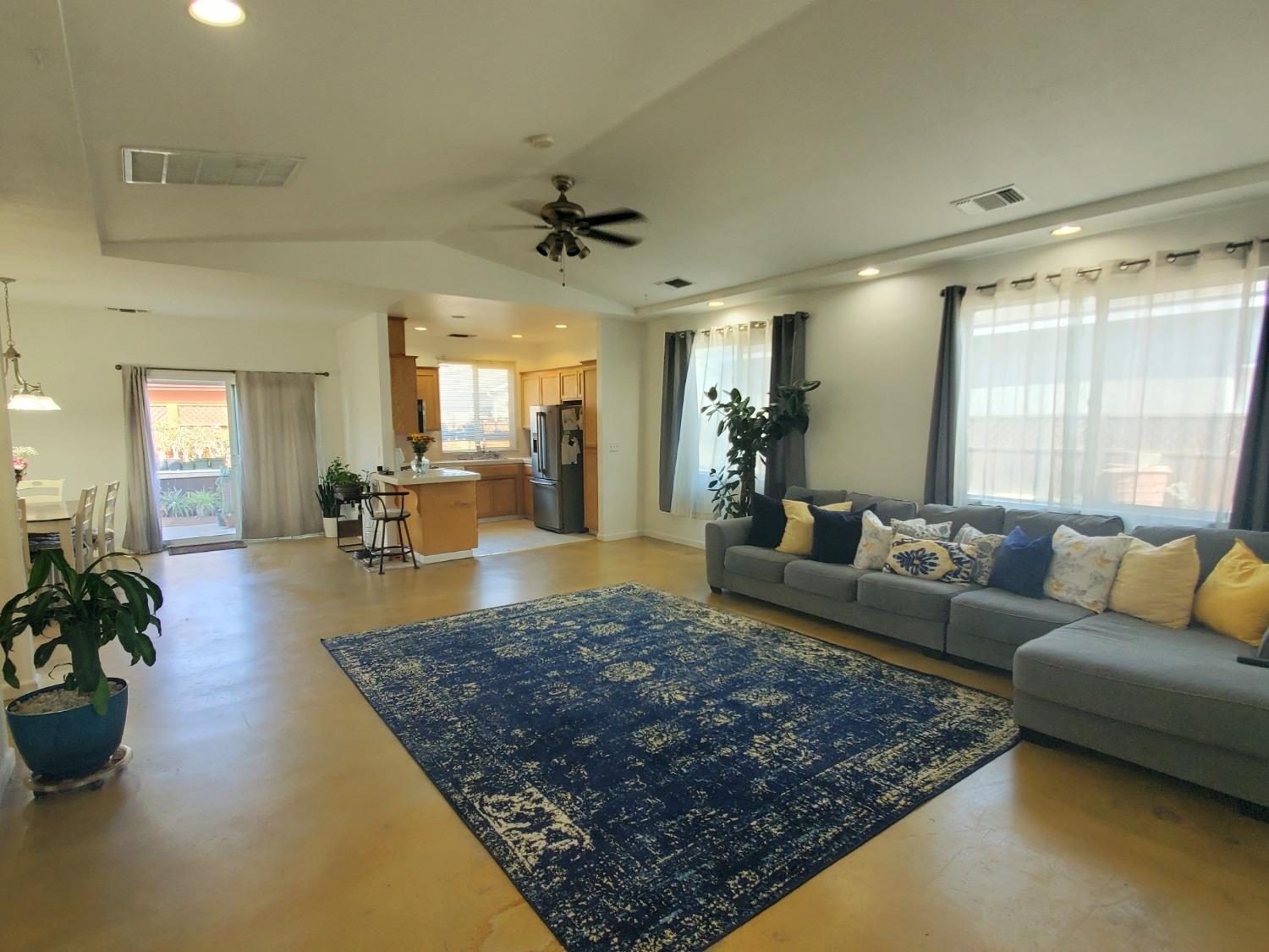 359 Amber Dinuba, CA 93618 - Photo 2 of 22 a living room with furniture rug and a large window