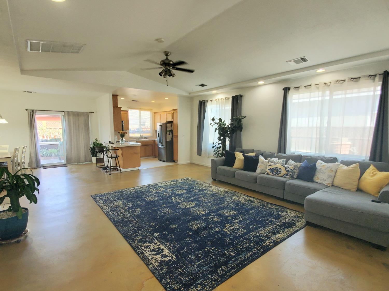 359 Amber Dinuba, CA 93618 - Photo 3 of 22 a living room with furniture rug and a large window