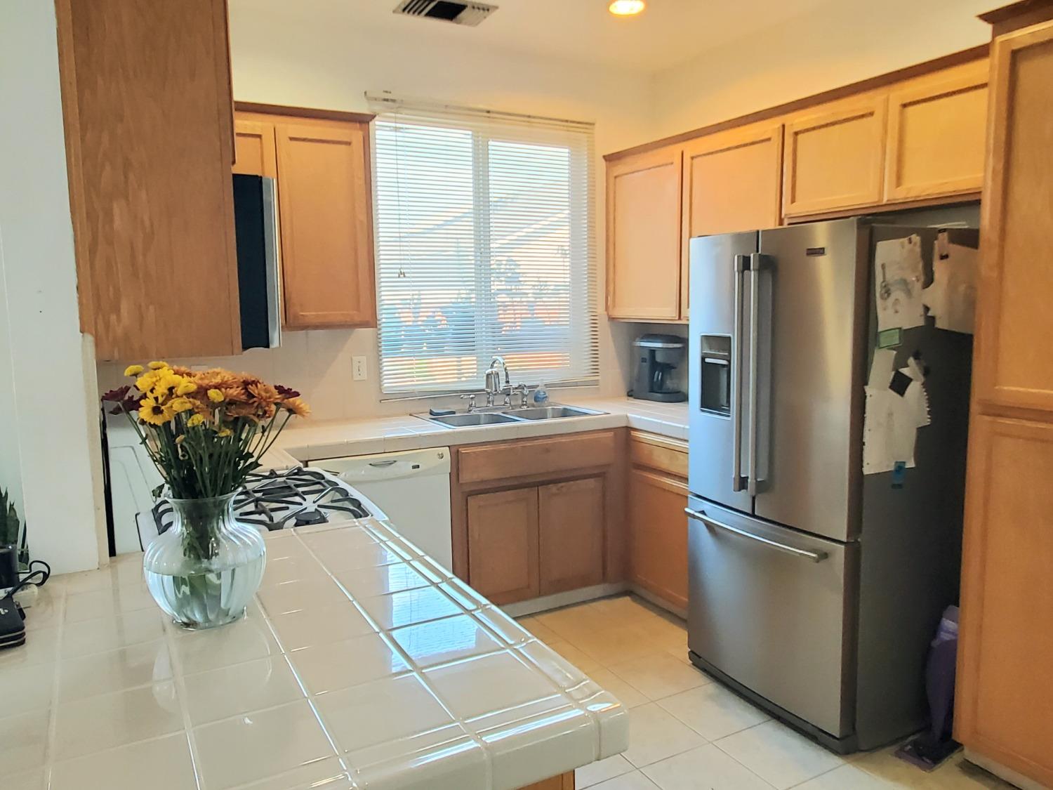 359 Amber Dinuba, CA 93618 - Photo 5 of 22 a kitchen with stainless steel appliances granite countertop a refrigerator and a stove