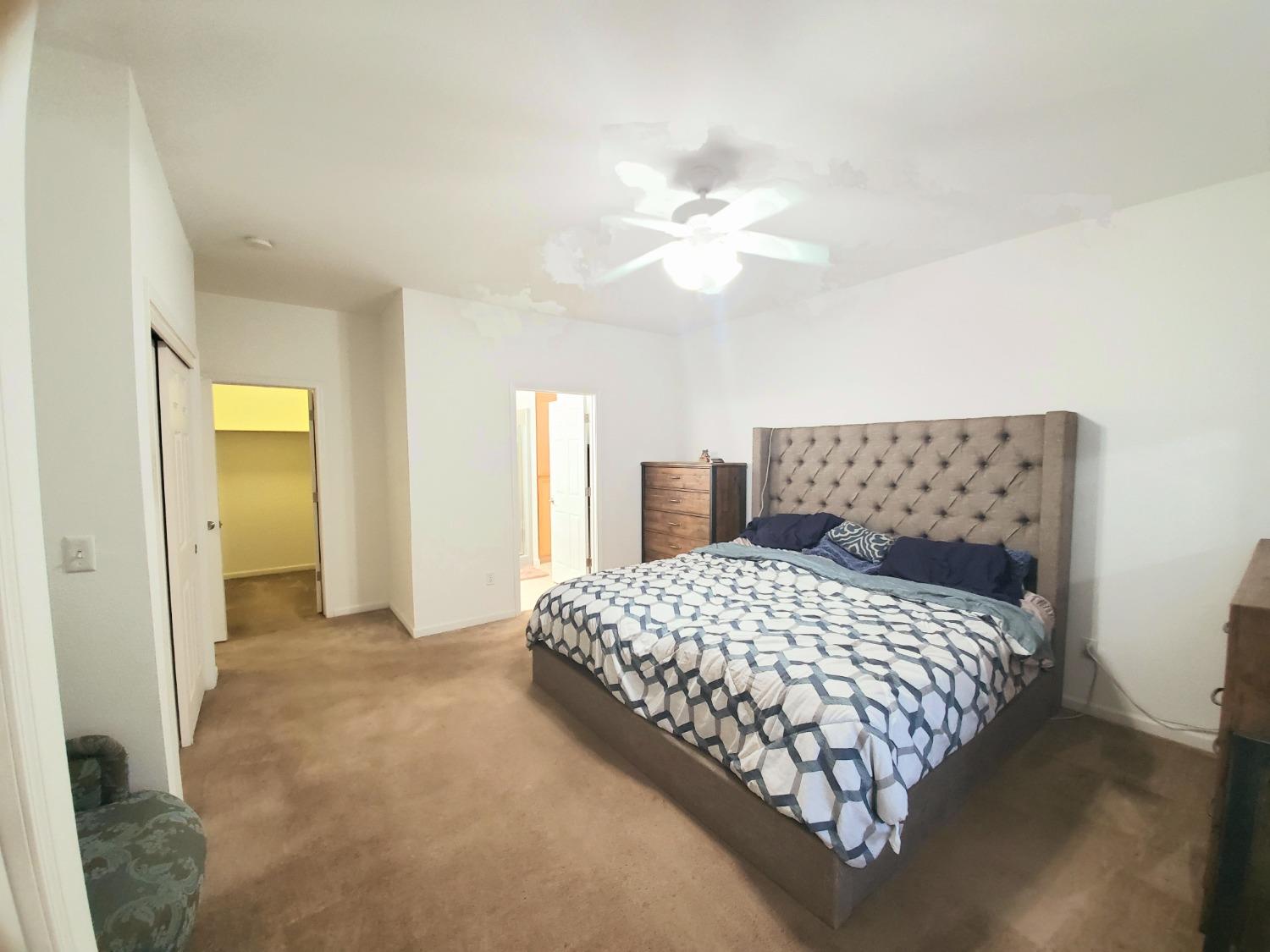 359 Amber Dinuba, CA 93618 - Photo 9 of 22 a bedroom with a large bed and chandelier