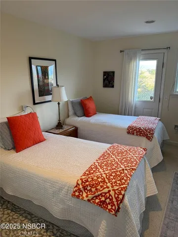 a bedroom with two beds and a window