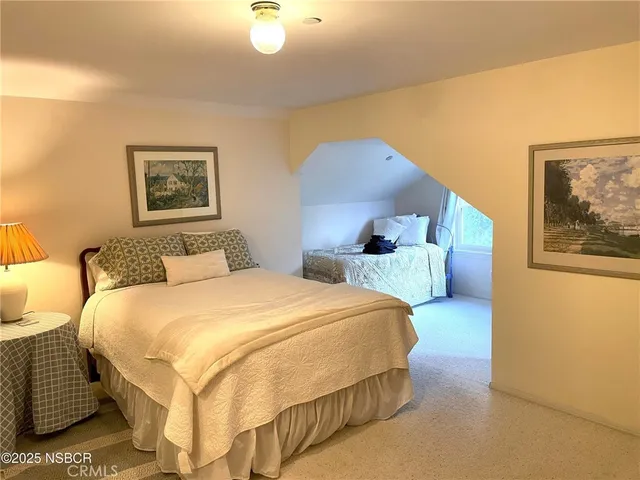 a bedroom with bed and wall painting