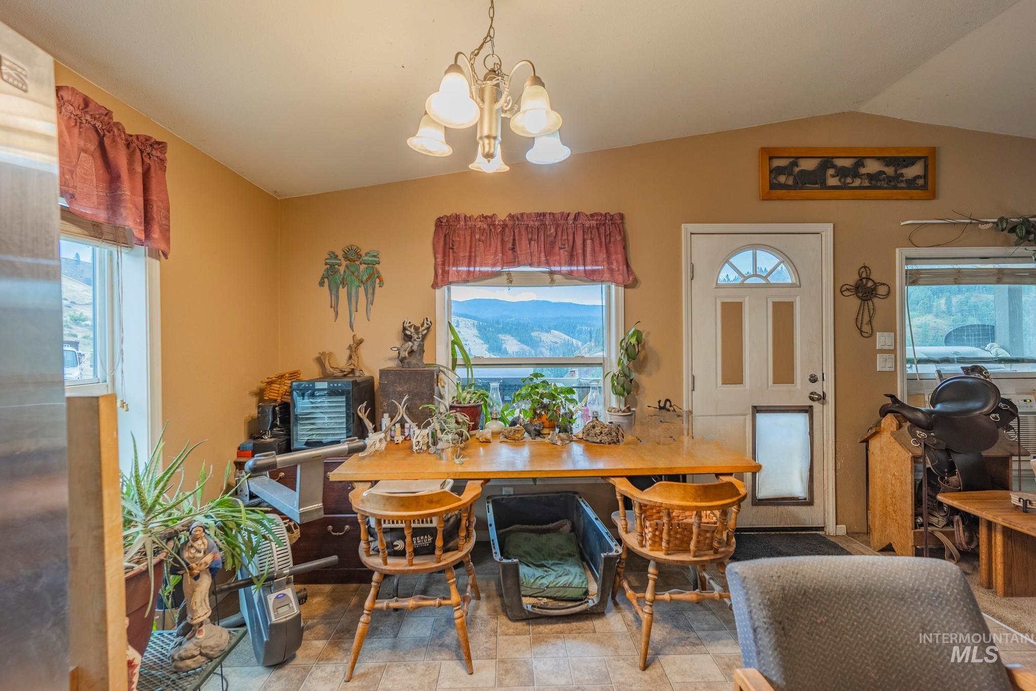 3608 Highway 13 Stites, ID 83552 - Photo 16 of 44 Dining space featuring healthy amount of natural light, a chandelier, and lofted ceiling