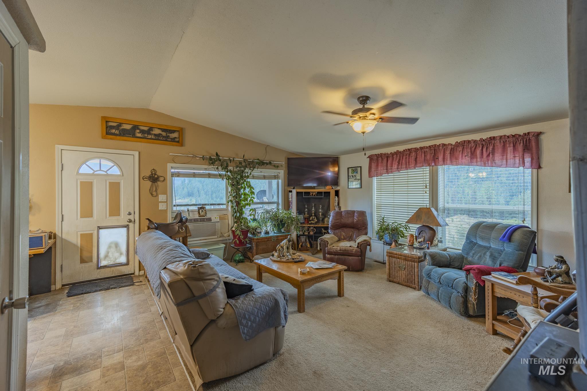 3608 Highway 13 Stites, ID 83552 - Photo 19 of 44 Living room with lofted ceiling, ceiling fan, and stone finish flooring