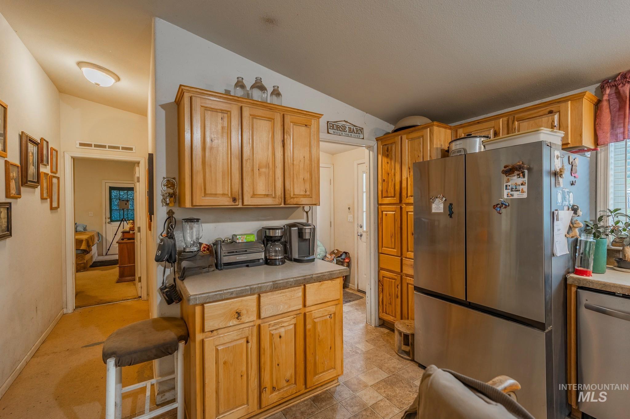 3608 Highway 13 Stites, ID 83552 - Photo 25 of 44 Kitchen with appliances with stainless steel finishes, lofted ceiling, and light countertops