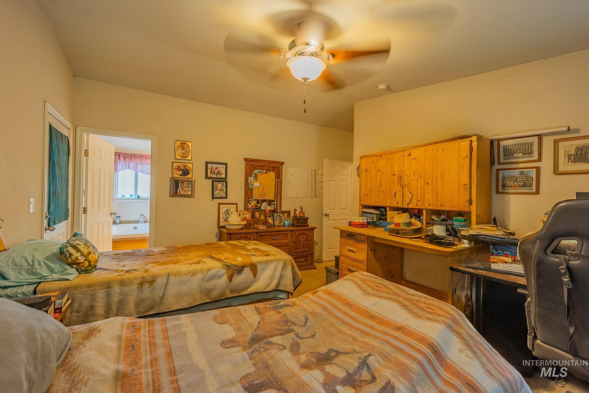 3608 Highway 13 Stites, ID 83552 - Photo 29 of 44 Bedroom with an office area, a ceiling fan, and ensuite bathroom