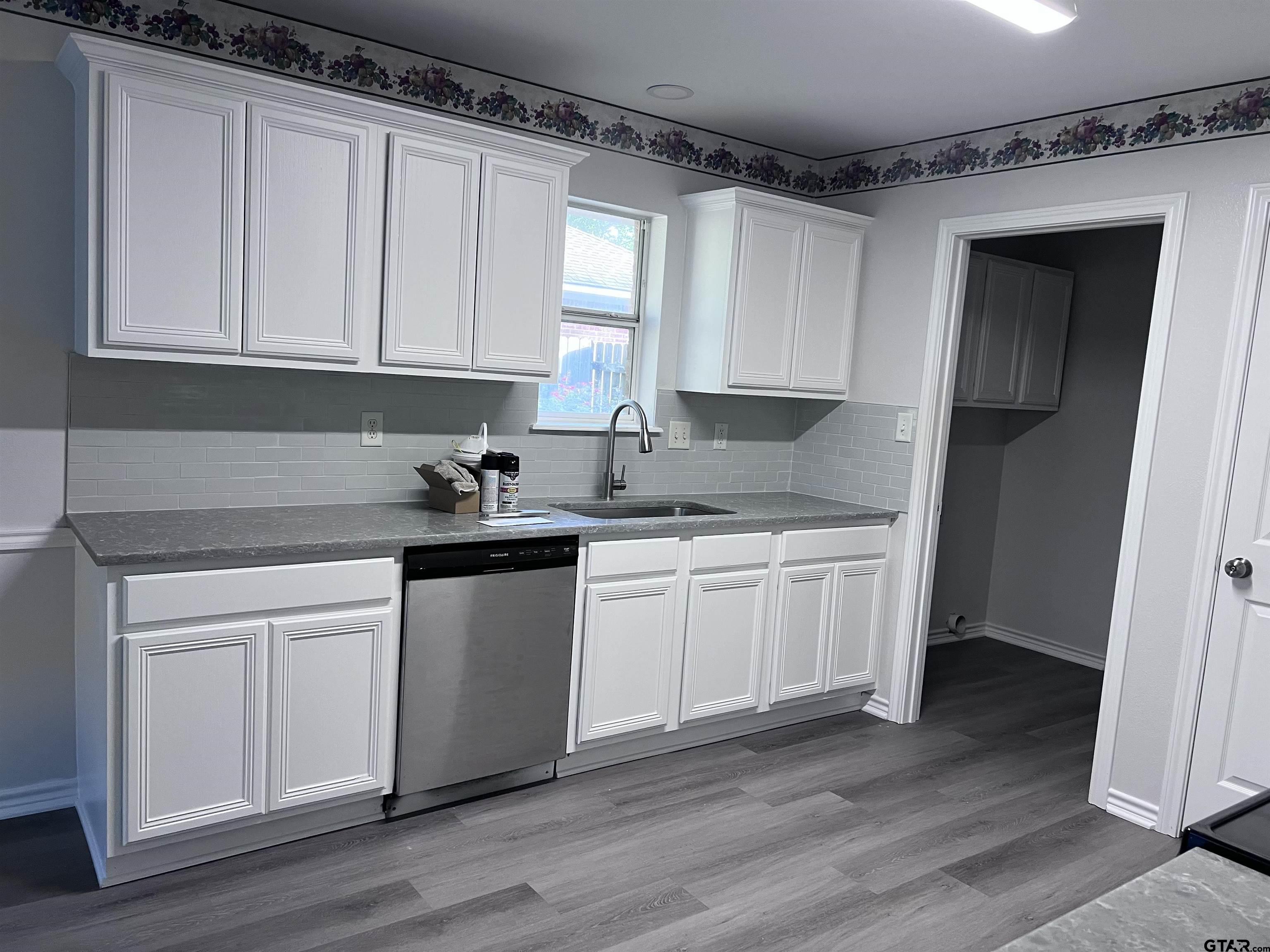 16583 County Road 164 Flint, TX 75762 - Photo 2 of 22 a kitchen with granite countertop white cabinets and white appliances