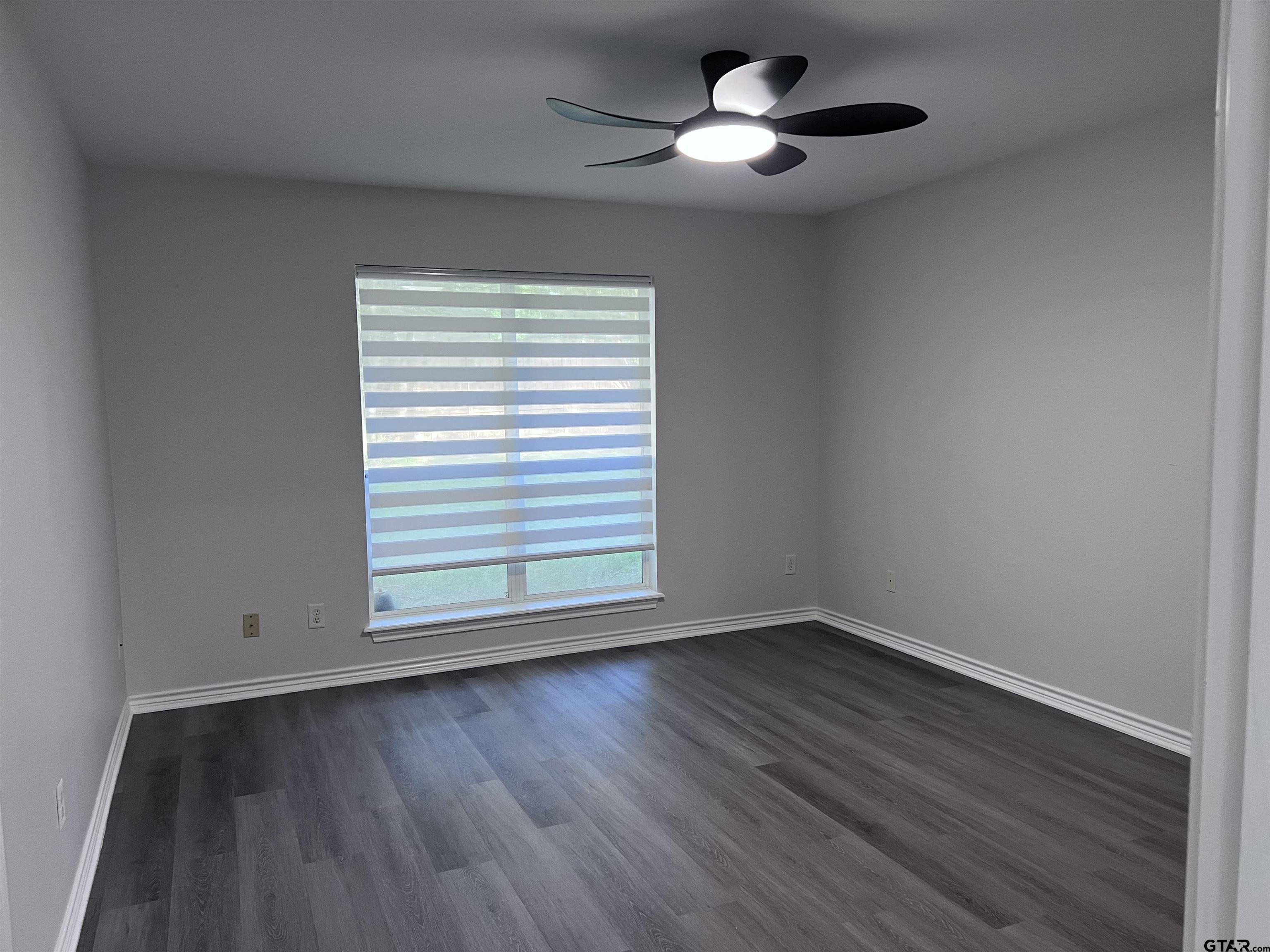 16583 County Road 164 Flint, TX 75762 - Photo 7 of 22 a view of an empty room with wooden floor and a window