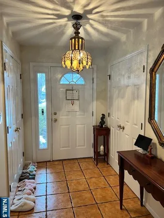 a view of a entryway door of the house and dining room