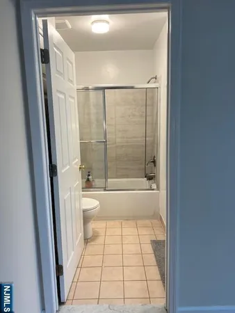 a bathroom with a toilet a sink and a shower