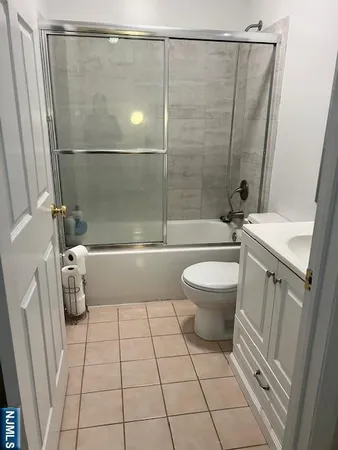 a white toilet sitting next to a bathroom sink