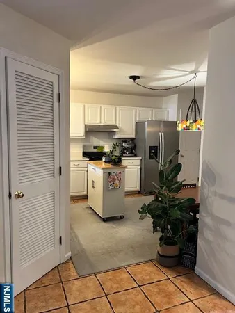 a kitchen with stainless steel appliances granite countertop a sink a stove and cabinets