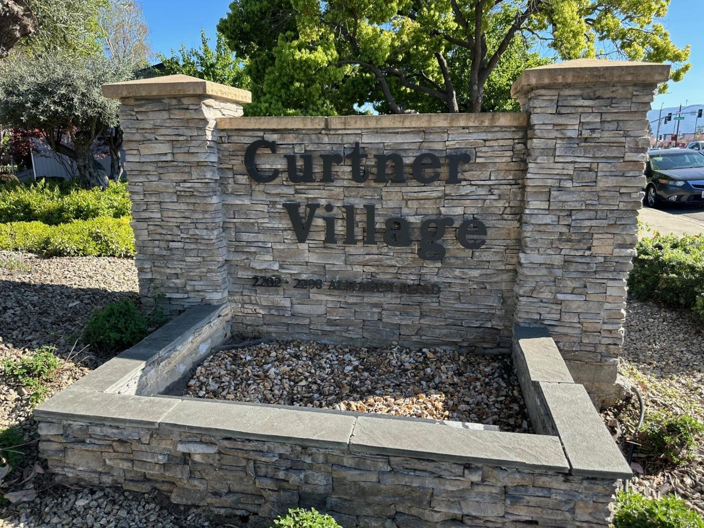 a view of a brick house with a yard