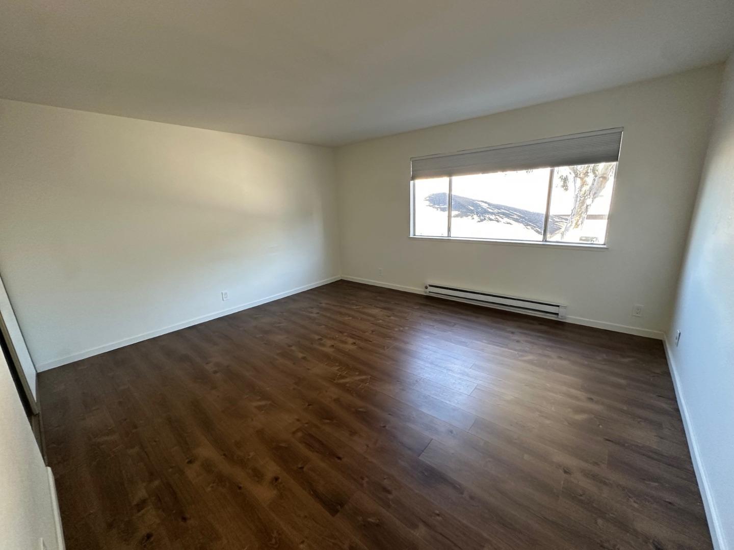 2212 Almaden Road, Unit A San Jose, CA 95125 - Photo 8 of 15 an empty room with wooden floor and windows