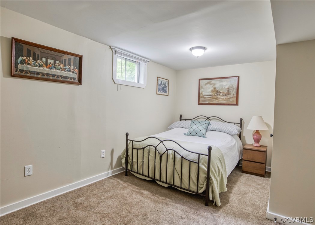 240 Cedar Ridge Drive Ruther Glen, VA 22546 - Photo 20 of 34 a bedroom with a bed and a painting on the wall