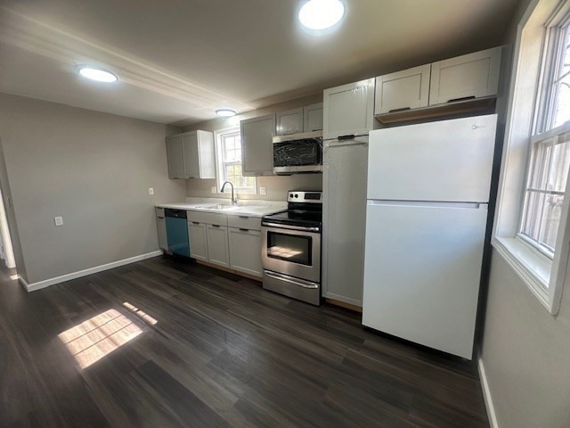 15-17 Otis Court, Unit 15 Springfield, MA 01119 - Photo 5 of 16 a kitchen with kitchen island wooden floors appliances and white cabinets