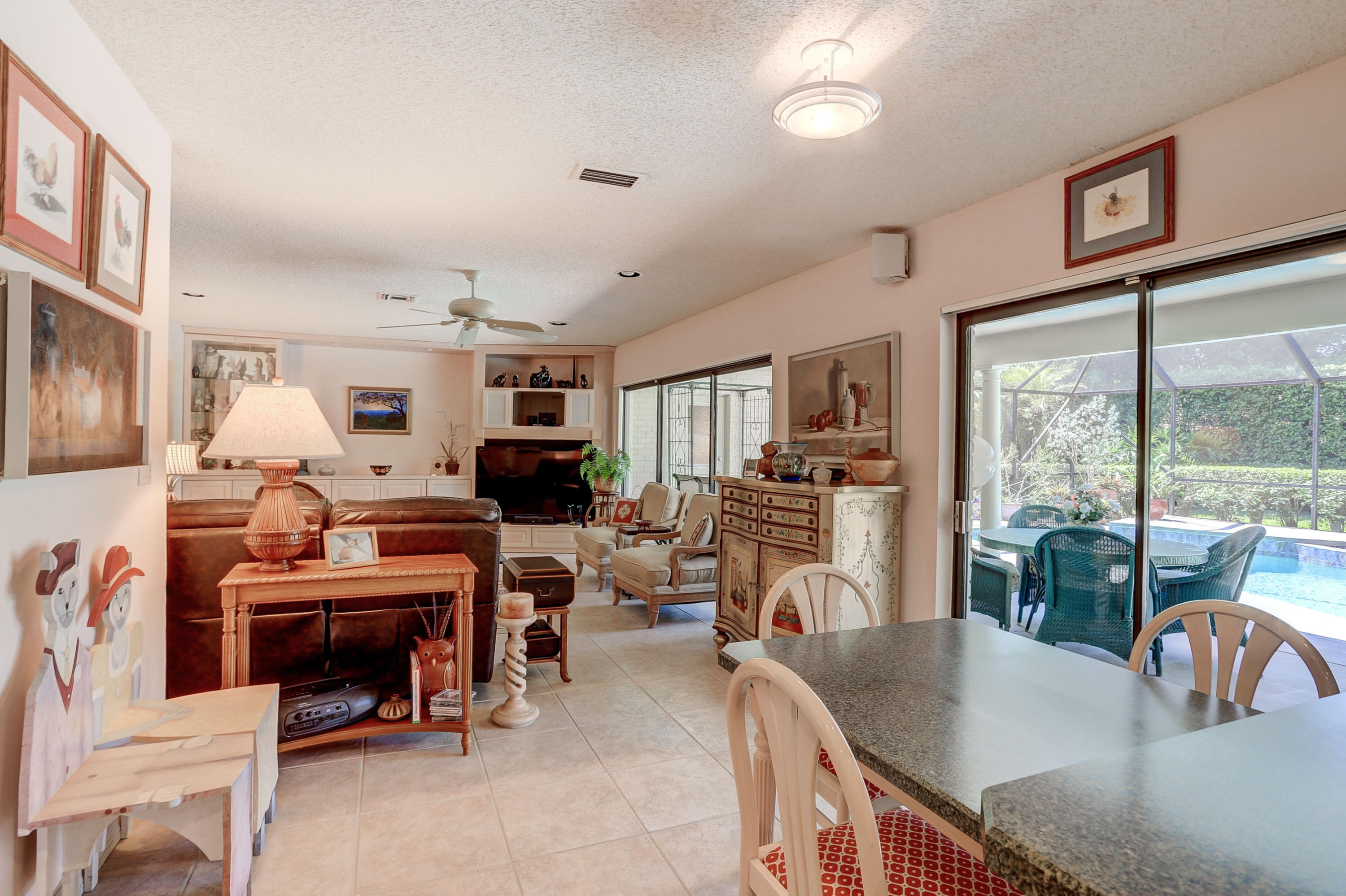 6835 Viento Way Boca Raton, FL 33433 - Photo 13 of 43 a living room with furniture a large window and a dining table