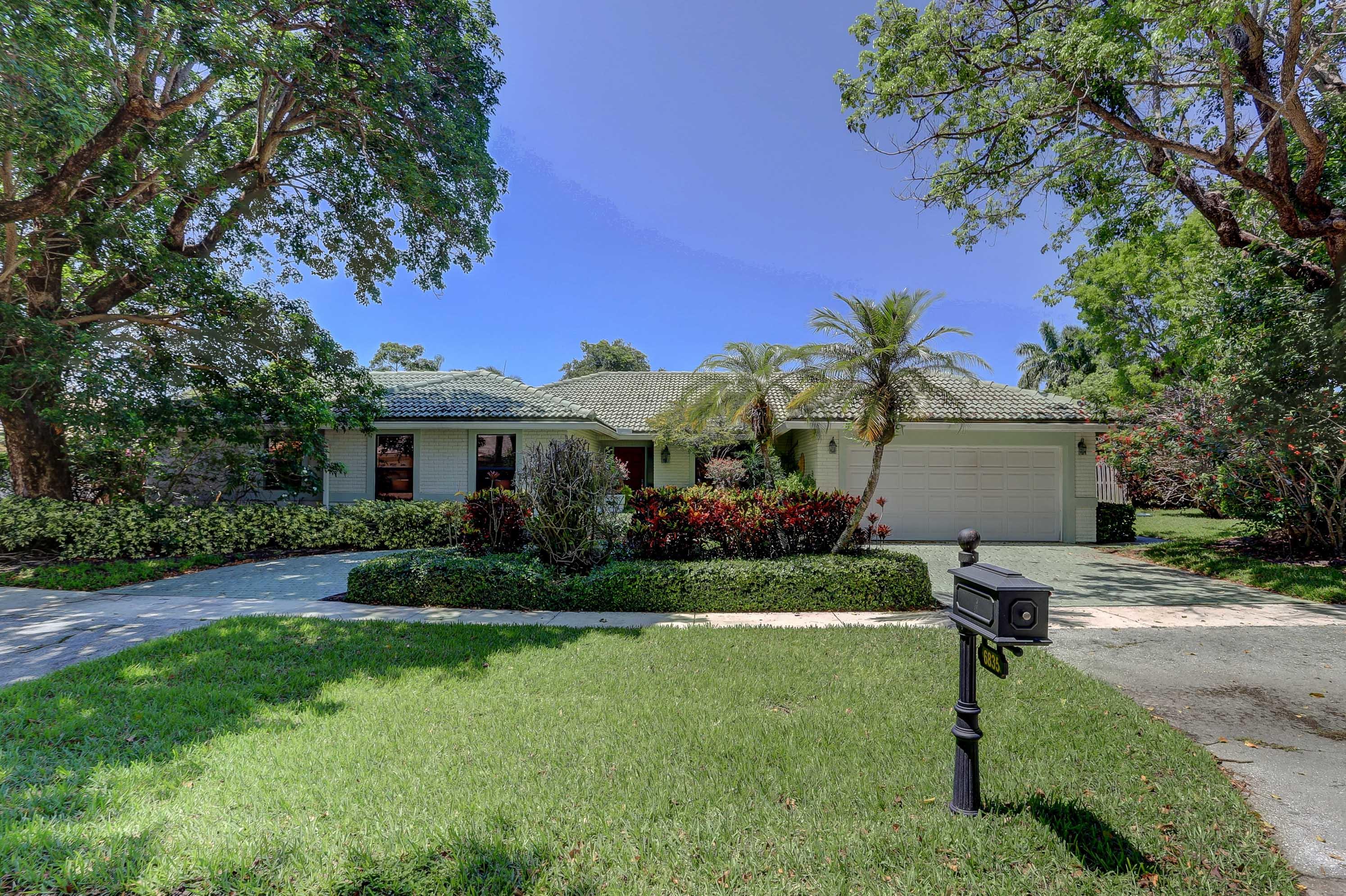 6835 Viento Way Boca Raton, FL 33433 - Photo 2 of 43 a front view of a house with garden