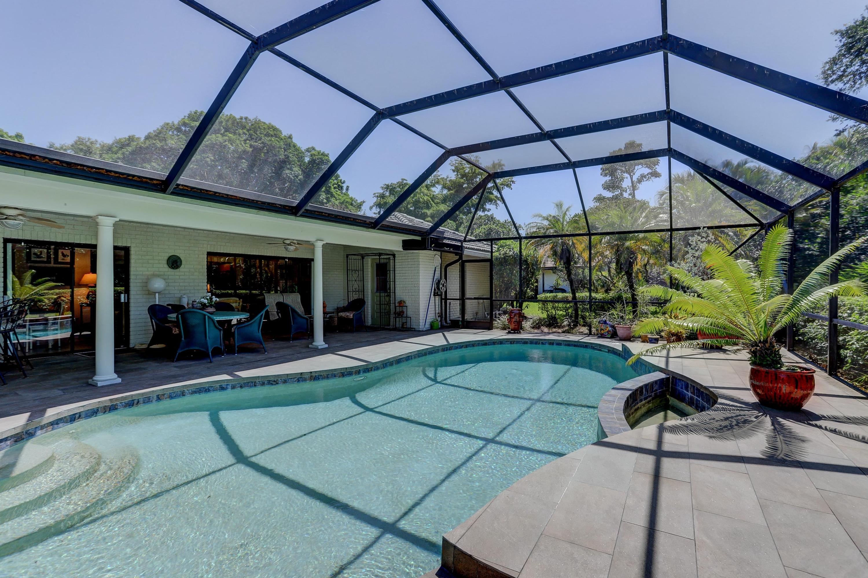 6835 Viento Way Boca Raton, FL 33433 - Photo 34 of 43 a view of a chairs and table in the patio