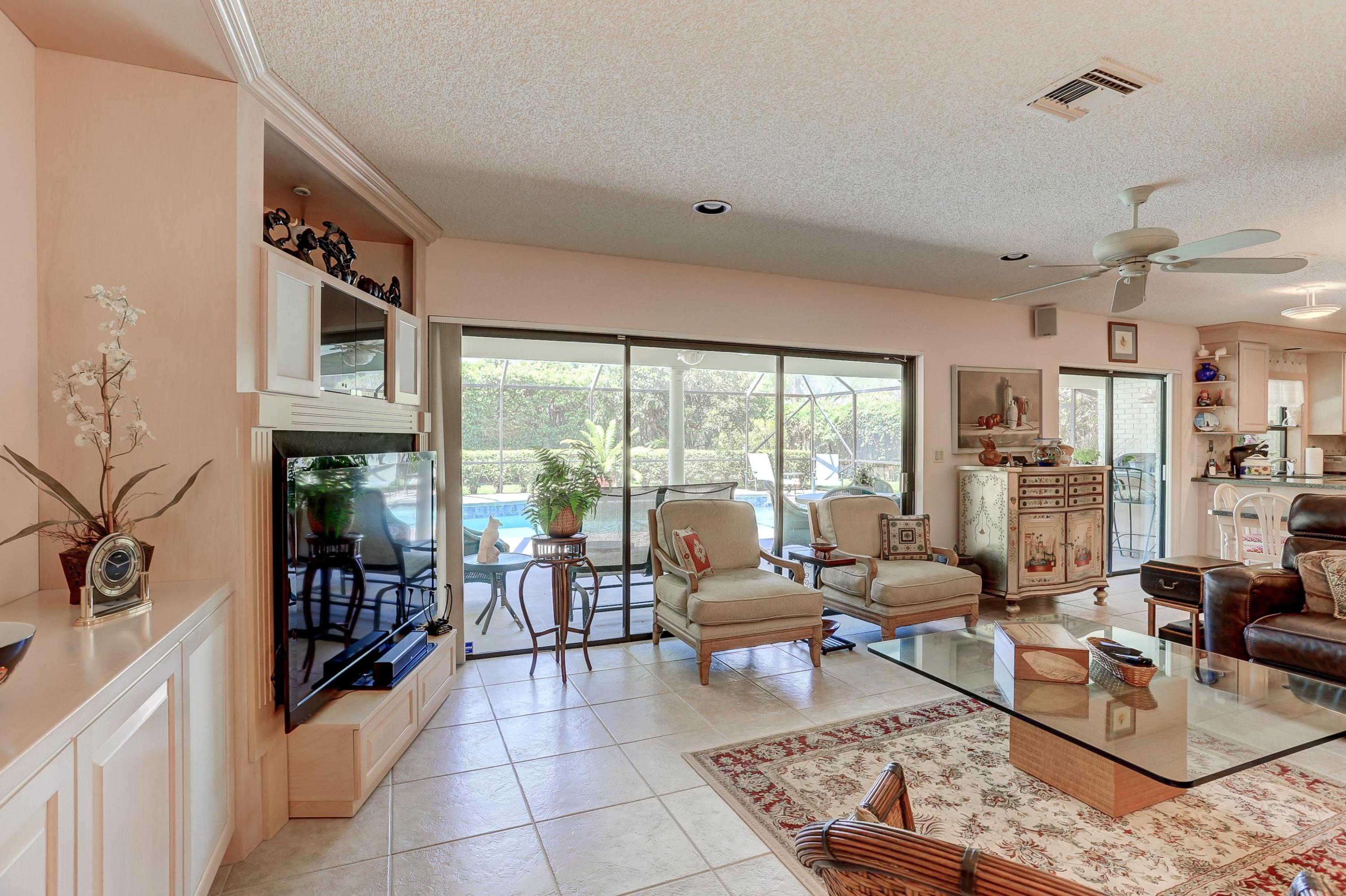 6835 Viento Way Boca Raton, FL 33433 - Photo 10 of 43 a living room with fireplace furniture and a large window