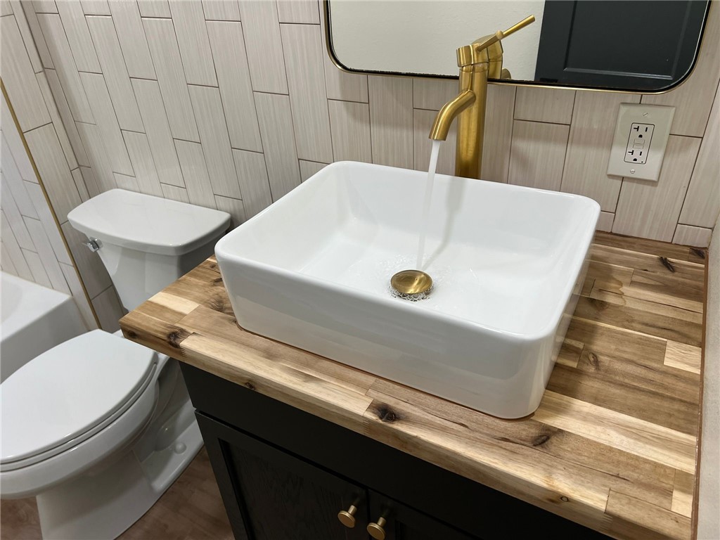 4501 College Main Street, Unit 1 Bryan, TX 77801 - Photo 5 of 8 a bathroom with a sink and a toilet