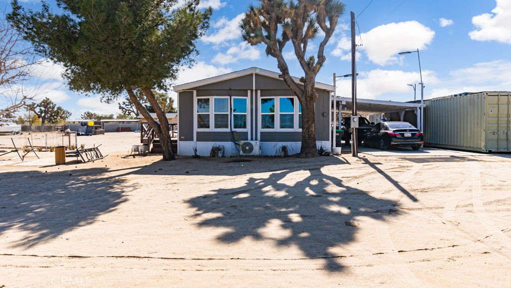 6573 Dos Palmas Road Phelan, CA 92371 - Photo 1 of 1 a view of a house with a patio