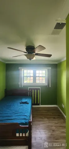 a view of a room with wooden floor and a window