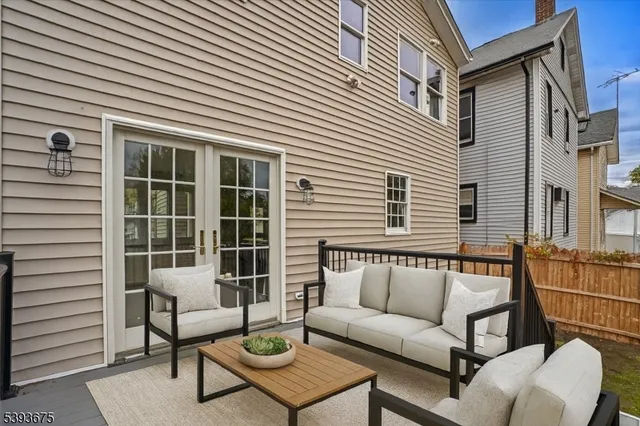 a view of a patio with couches and a potted plant on a table