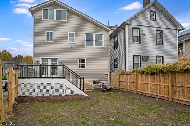 a view of a house with wooden fence