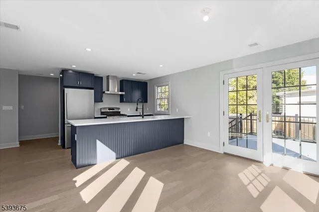 a kitchen with stainless steel appliances granite countertop a refrigerator sink and cabinets