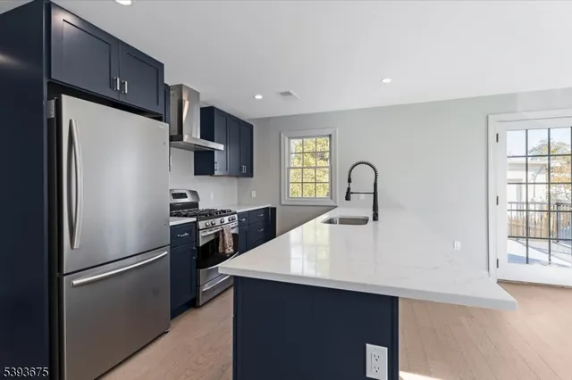 a kitchen with a refrigerator sink and cabinets