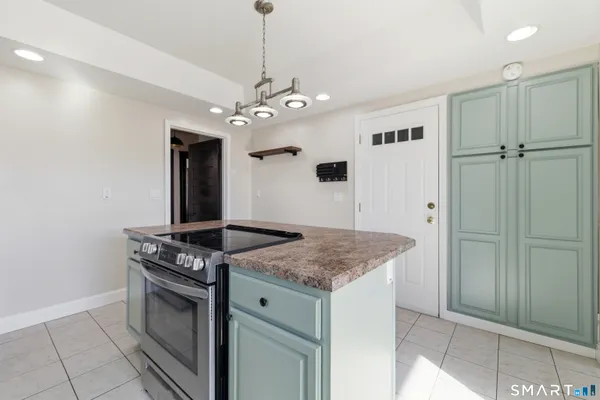 a kitchen with stainless steel appliances granite countertop a stove and a sink