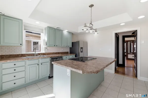 a kitchen with cabinets and chandelier
