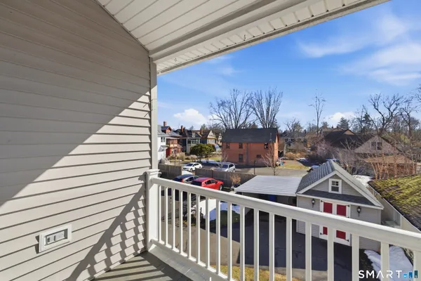 a view of a balcony with an outdoor seating
