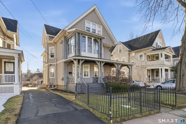 a front view of a house with iron fence