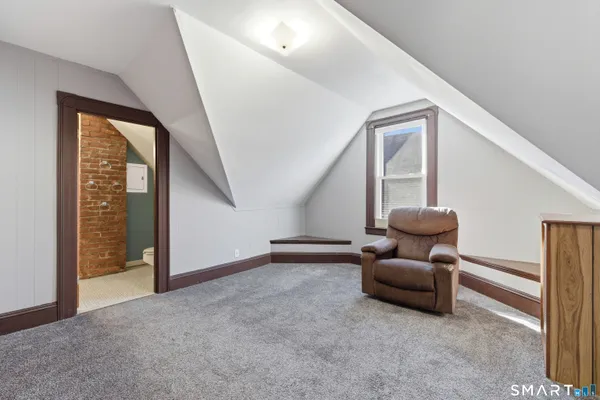 a view of an empty room with closet and entryway
