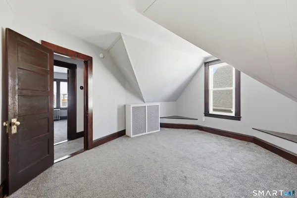 an empty room with windows and closet